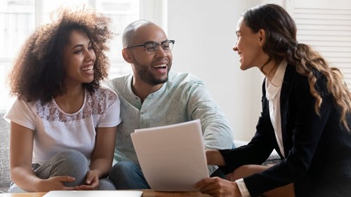 Advisor Speaking To smiling Clients