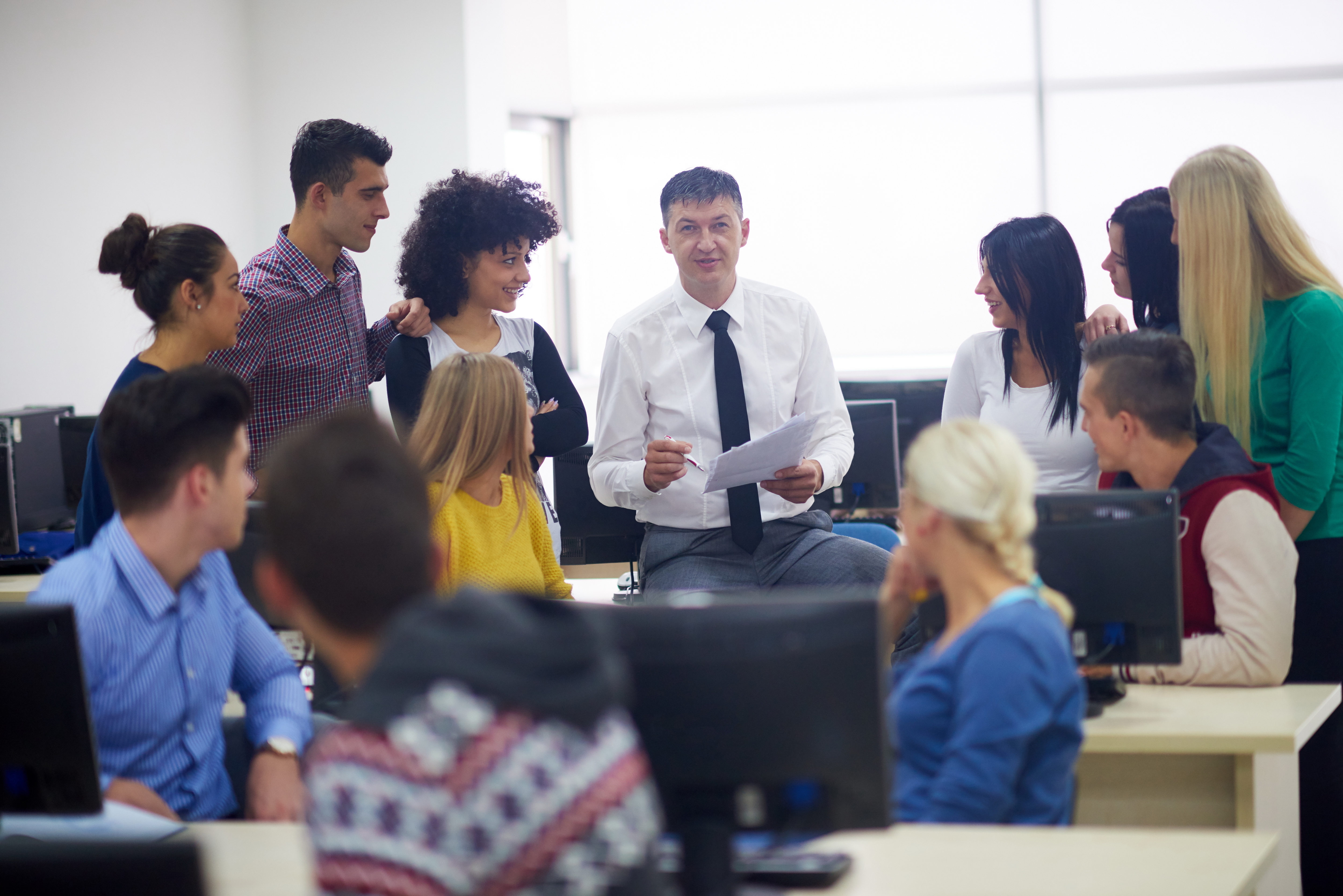 Teacher Surrounded By Students