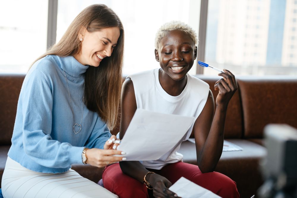 Two young women talking and laughing